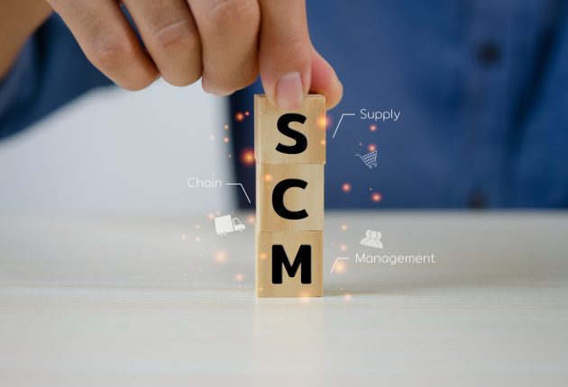 Hand put wooden cubes SCM Supply Chain Management .Business mark Hand put wooden cubes SCM Supply Chain Management .Business marketing Concept